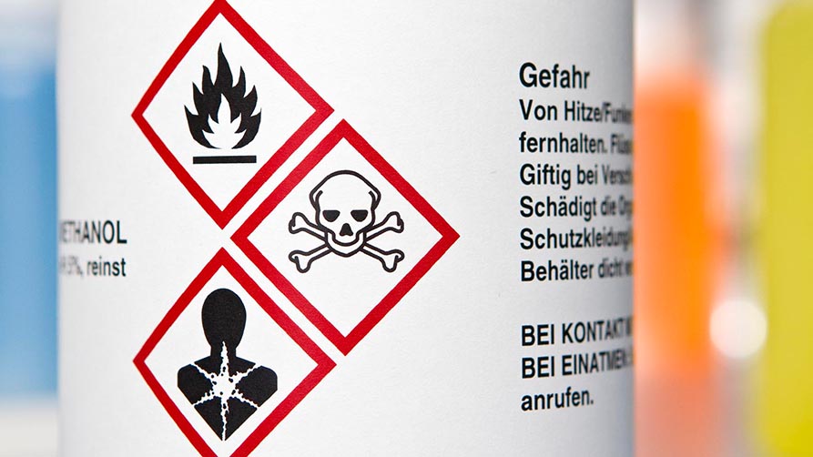 three hazard symbols on a laboratory bottle three hazard symbols on a laboratory bottle