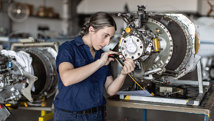 © iStock/LOUISE BEAUMONT Woman works on a machine