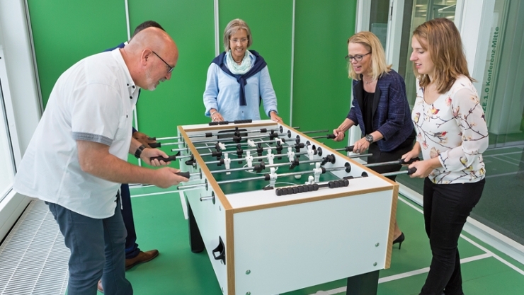 Employees play table soccer